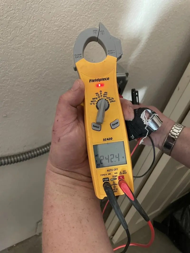 Voltage testing with clamp meter during Recessed Lighting Installation in Forest City